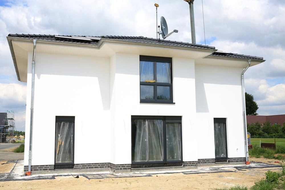 Neubau eines weißen Einfamilienhauses mit Kunststofffenstern und Flachdach – Bauprojekt von Dahl Bau in Stadecken-Elsheim